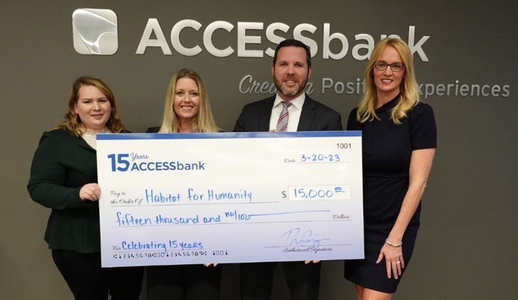 ACCESSbank staff presented a check to Omaha's Habitat for Humanity as part of the bank's 15th anniversary celebration.