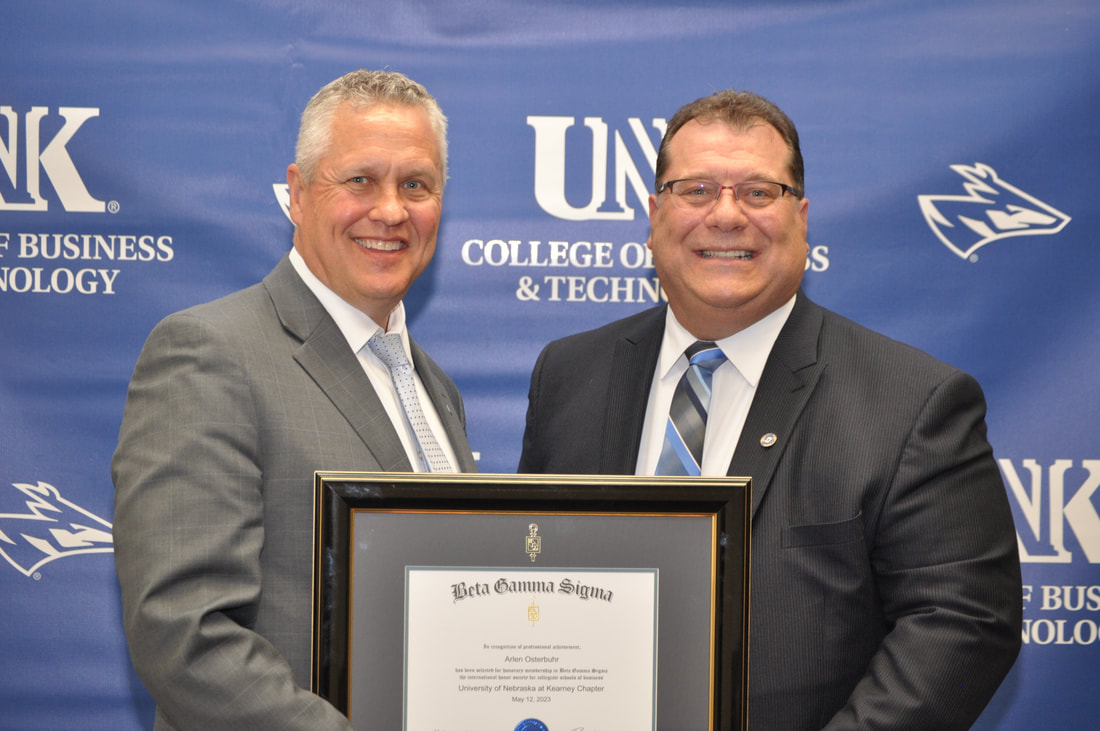 Arlen Osterbuhr (right) receives a certificate of honorary membership with UNK's Betta Gamma Sigma chapter from Tim Jares, dean of UNK's College of Business and Technology.