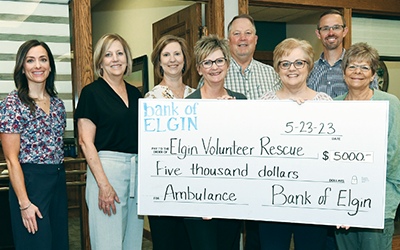 L to R: Samantha Stoltz, Anne Parks, Susan Kallhoff, Tracy Beckman, Gary Arehart, Deb Tharnish, Michael Moser and Lori Beckman from the Bank of Elgin presented a check to the Elgin Rescue Squad.
