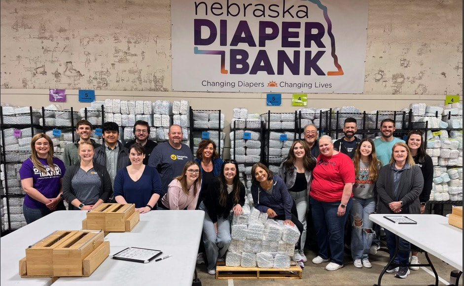Eighteen staff members from Dayspring Bank in Omaha volunteered at the Nebraska Diaper Bank. They wrapped nearly 19,000 diapers in an hour and a half.