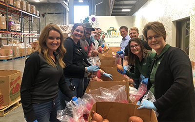 Bankers from the First National Bank of Omaha recently helped fill food bags for those in need.