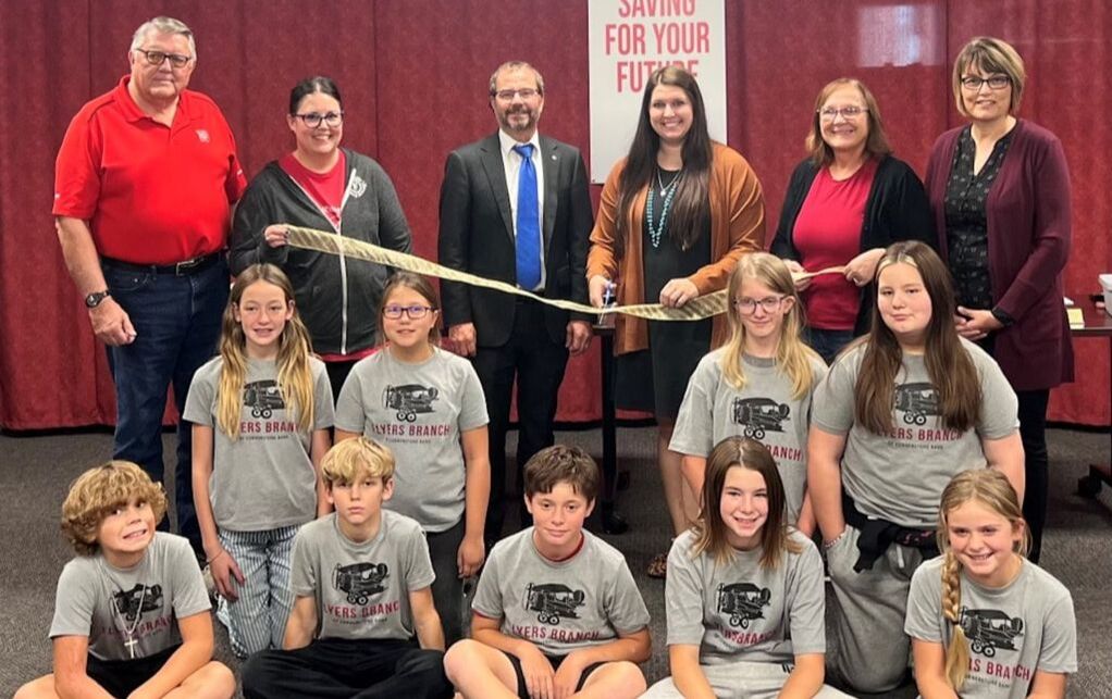 Cornerstone Bank employees, the Franklin Chamber of Commerce and students from Franklin Public Schools celebrated the grand opening of an in-school savings bank branch with a ribbon-cutting ceremony.