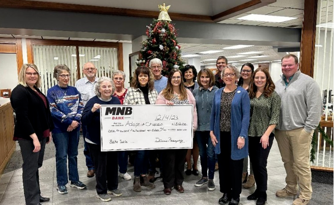 MNB Bank staff presented a check for $1,510 to representatives of the Adopt-A-Chaplain program.